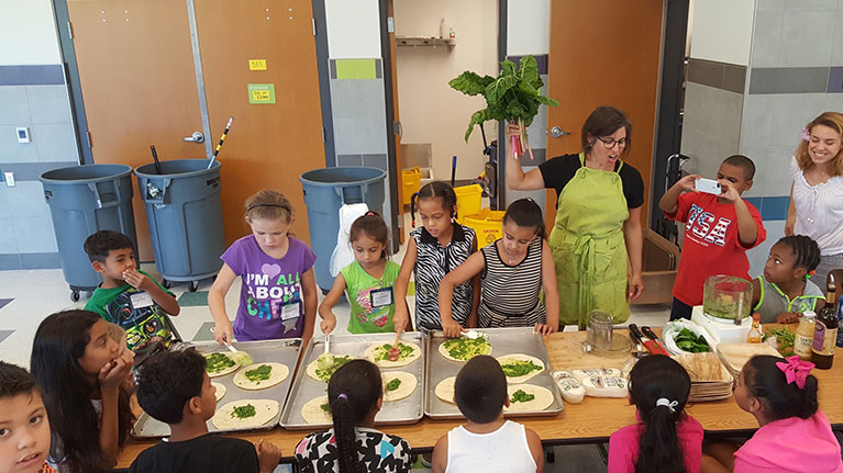 Group of young students in cooking class with teacher