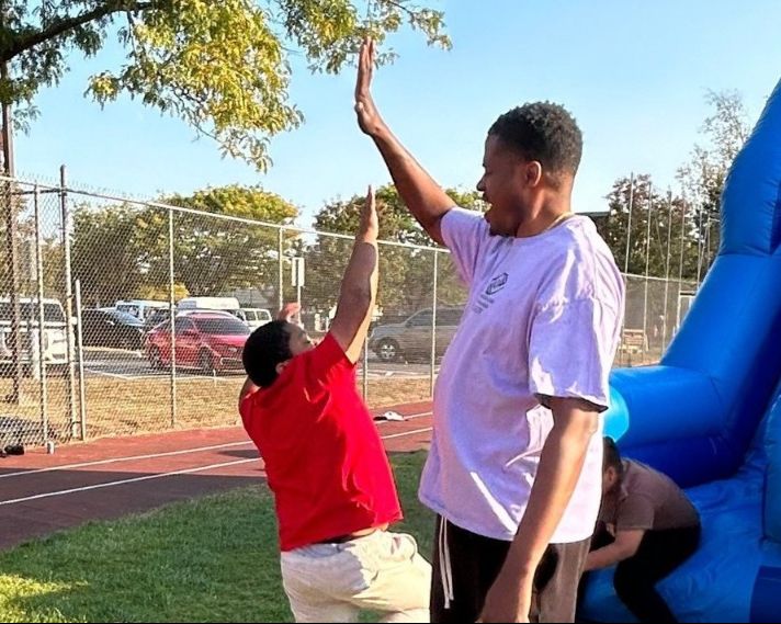 afterschool student at the boys and girls club high fives James Jones THUMB.jpg