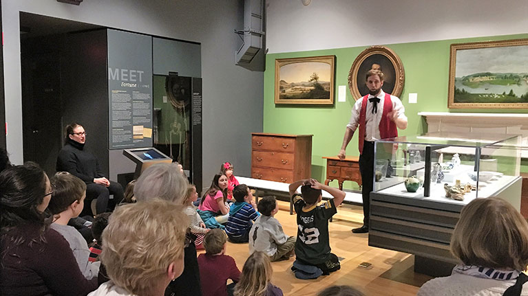 Group of students and an actor portraying Abraham Lincoln at Mattatuck Museum