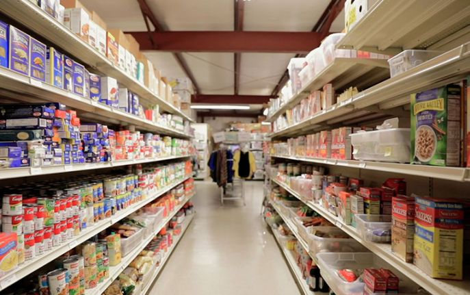 View of looking down an aisle with stocked shelves of food
